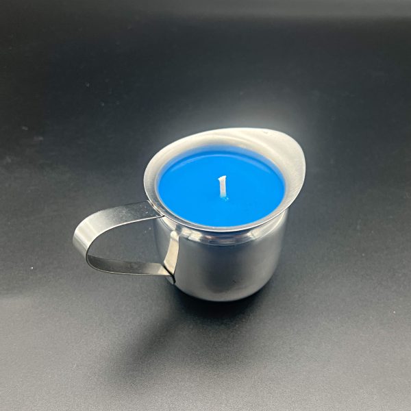 Five ounce stainless steel container with pour spout and handle filled with blue soy wax