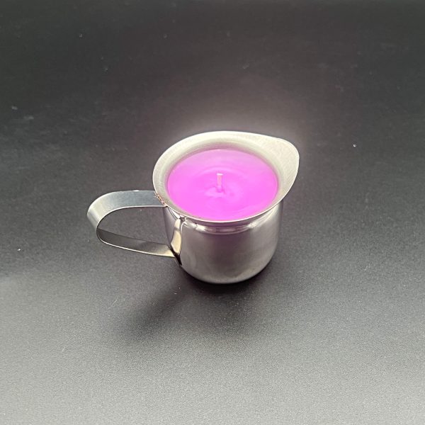 5 ounce stainless steel container with pour spout and handle filled with pink-dyed paraffin wax
