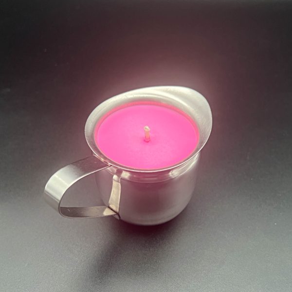 Large stainless steel 5 ounce container - bell creamer - with a handle and pour spout. It is filled with a bright pink soy wax