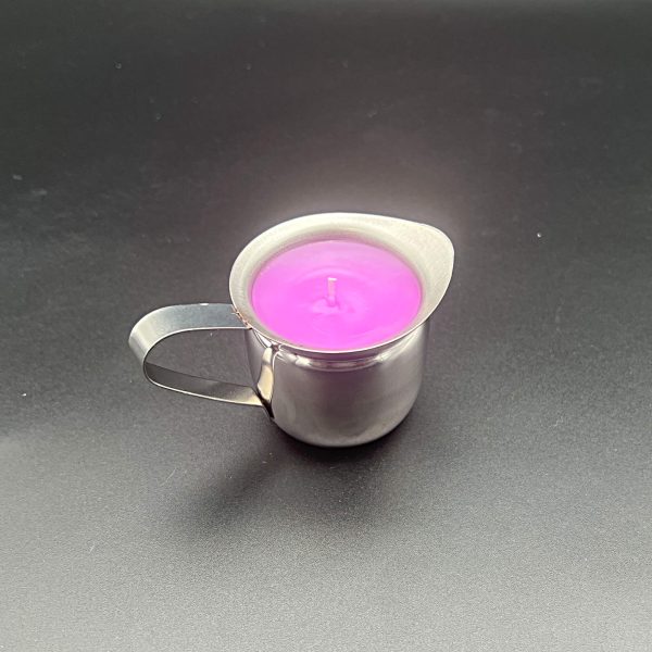 3 ounce stainless steel container with handle and pour spout filled with pink-dyed paraffin wax