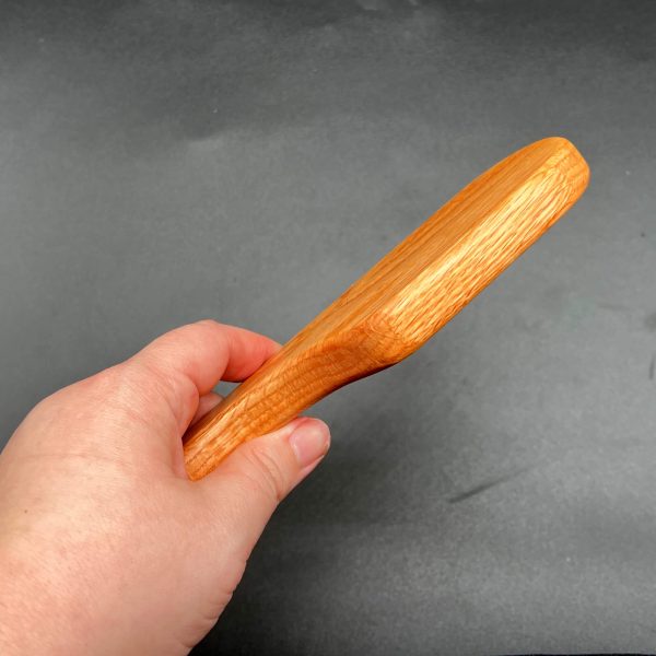 Side view of the white oak pocket paddle to show the thickness