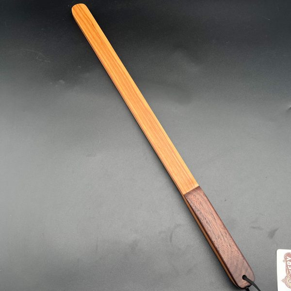 Thick stick made of unknown wood -- it's a red brown wood with a strong vertical grain pattern in a darker brown color.