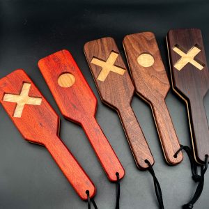 An array of XOXO paddles, from left to right: Bloodwood, Black Walnut, Rosewood. The sides of the paddle showing, left to right, X, O, X, O, X