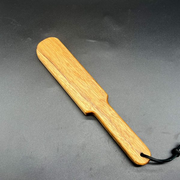 Wooden paddle made of Black Limba, a yellow-brown-grayish wood