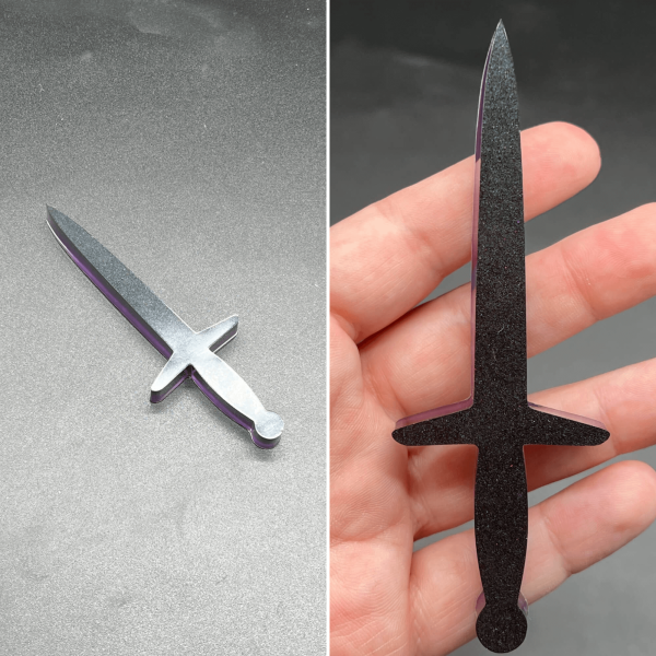 This longsword style dagger is made with black resin and purple resin. The purple is visible on the back.