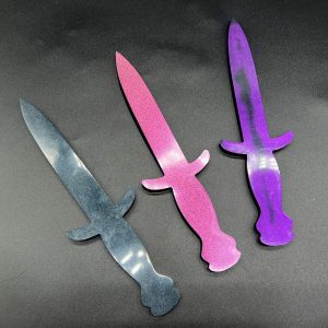 Three Knightly resin daggers - black, pink shimmer, and purple and black