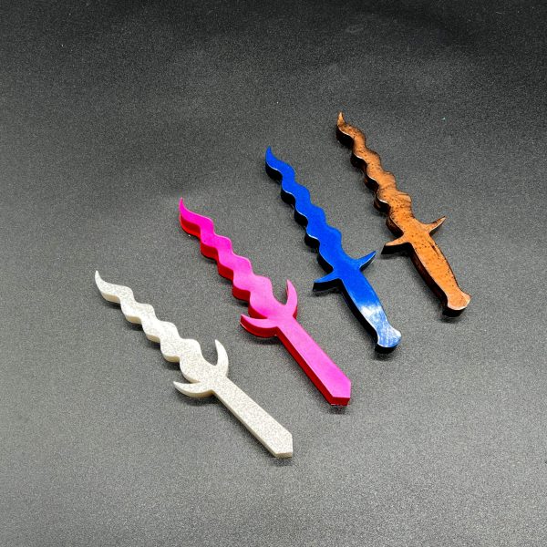 Four Kris resin daggers: white, pink, blue, and brown