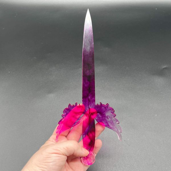 Clear resin dagger with swirls of purple throughout - the entire dagger is translucent