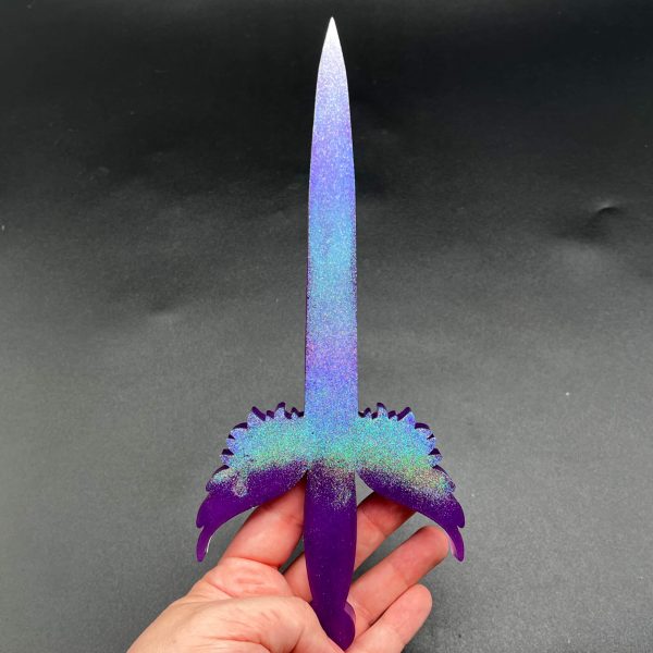 Purple resin dagger with a blue-purple holographic glitter on the blade and top of the hilt