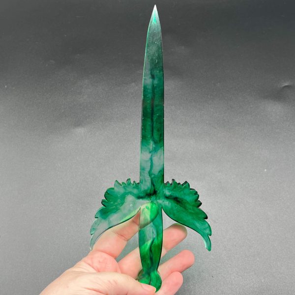 Clear resin dagger with swirls of green ink throughout. The dagger is translucent.