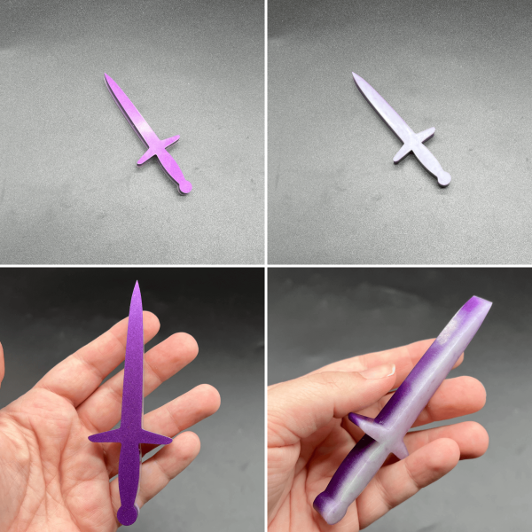 This longsword style dagger is made with purple resin and white resin. The purple is visible on the front of the dagger, and the white is visible on the back.