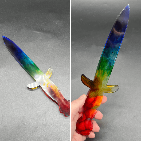 Clear resin dagger with swirls of translucent color in reverse rainbow order.