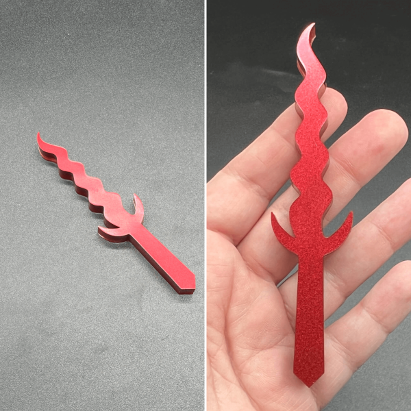 This Kris style dagger is made with red resin and is a solid color.