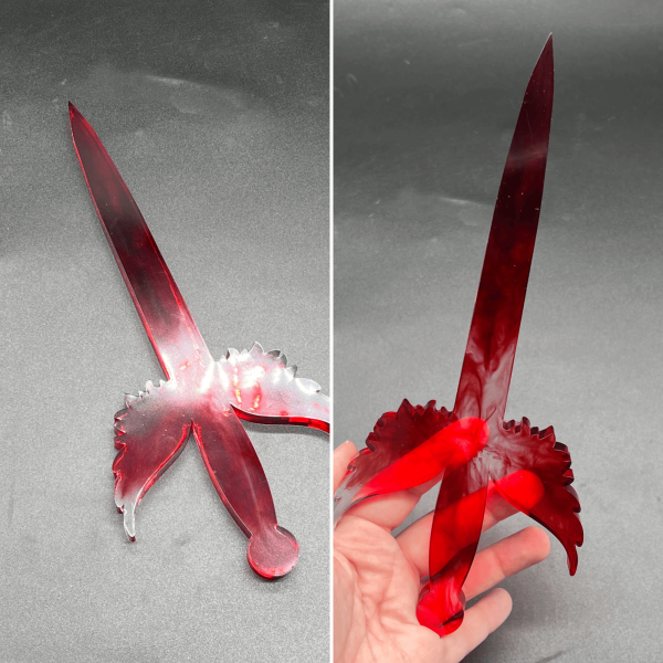 Clear resin dagger mixed with red alcohol ink to create swirls of color in the dagger