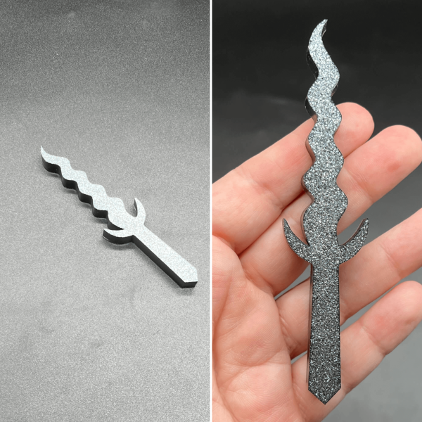 This Kris style dagger is made with black resin mixed with white glitter. The glitter sank to one side creating a silver sparkle along the entire front of the dagger.