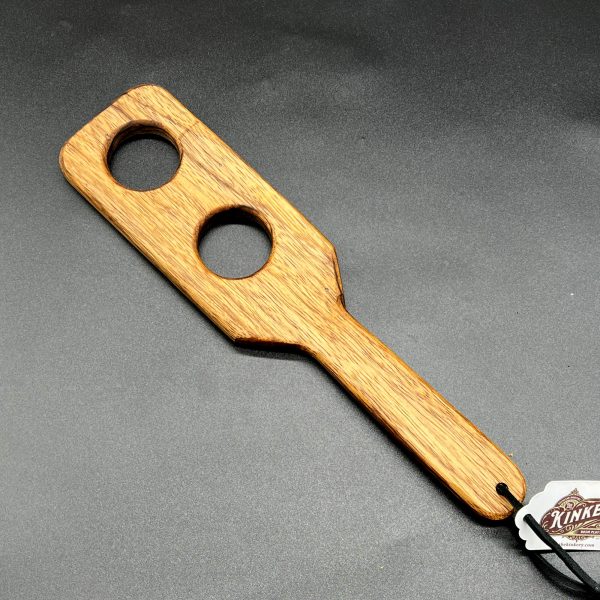 Holy Terror paddle made from Black Limba, a light brown wood with a dark, almost black grain pattern