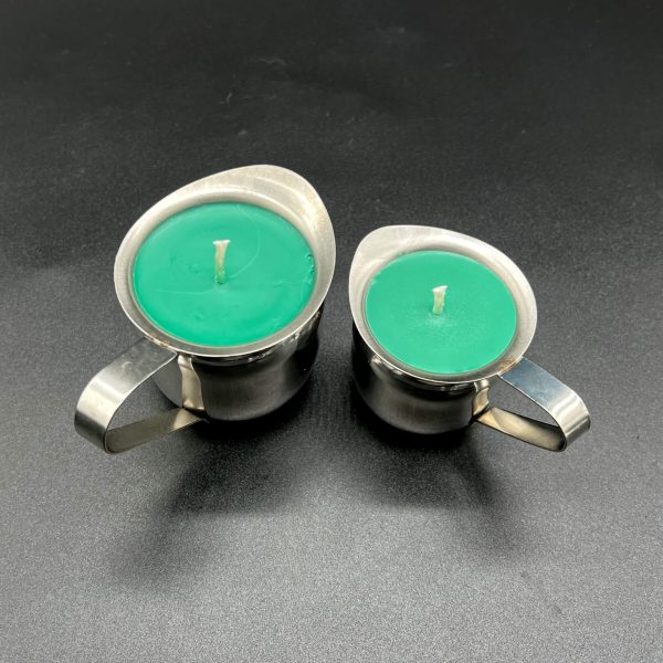 the 5 ounce and 3 ounce green soy wax play candles side by side. Each candle is in a stainless steel container with a handle and pour spout.