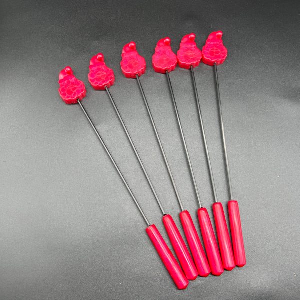 Group of Santa diabolical sticks. The tips are smiling Santa faces in red resin and the handles are also made of red resin.