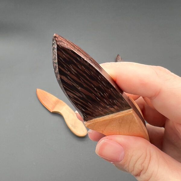 Close up of the Wenge skinner wooden knife blade to show how sharp and pointed the tip of the blade is