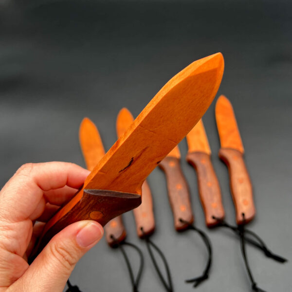 Close up of the sharp tip on the blade of the spearpoint wooden knife